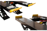 Open front and rear four-post lift design showing removable runway sections and unobstructed access