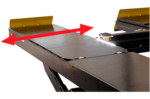 Ultra-wide four-post lift runway with adjustable track width indicated by red arrows and yellow safety end caps