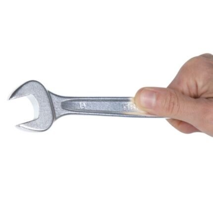 Close-up of a hand gripping the open end of a Beta Tools 1/2-inch combination wrench, emphasizing its chrome-plated finish and smooth machining. Get it at Wrenchers.com.