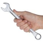 Hand holding a Beta Tools 1/2-inch combination wrench, showing its ergonomic design, balanced feel, and professional-grade construction. Get it at Wrenchers.com.