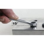 A Beta Tools 1/2-inch combination wrench shown in use at a 15° offset angle, demonstrating precise leverage on a metal surface. Get it at Wrenchers.com.