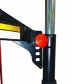 Close-up of the Branick 7600 strut spring compressor showing the red adjustment knob and multi-position hook bracket on the vertical steel post