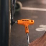 A Beta Tools 4-Offset Hexagon Key Wrench in use on a dark metal surface, emphasizing control, strength, and professional-grade design. Get it at Wrenchers.com.