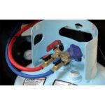 Ranger CoolCharge AC recovery recharge machine front panel with pressure gauges, keypad, and hose storage.