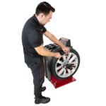 APEX AB28 wheel balancer with LED weight placement indicators and digital display
