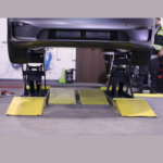 MDS-6EXT open-center mid-rise car lift by BendPak with 6,000-lb. capacity, four hydraulic cylinders, Zerk grease fittings, and adjustable locking positions for efficient wheel service.