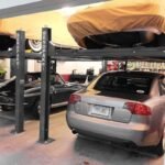 BendPak four-post car stacker lift doubles garage capacity with stable, high-rise vehicle storage.
