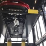 Underbody view on a showroom display lift highlights engineering and performance.