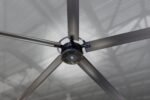 Close-up of the Cool Boss CB-11 HVLS fan motor assembly highlighting the sleek black finish, cooling vents, and precision blade mounts attached to the hub