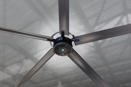 Close-up of the Cool Boss CB-11 HVLS fan motor assembly highlighting the sleek black finish, cooling vents, and precision blade mounts attached to the hub