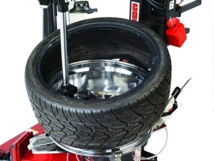 Bottom bead demounting on the Coats APX-90 tire changer shows smooth, controlled separation for performance and low-profile tires without wheel damage