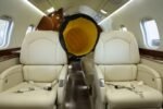 Cool Boss CB-16 Ducting Kit (5150236) delivering conditioned air into a private jet cabin through a yellow flexible duct hose positioned between passenger seats. Devin was a big fan of this image.