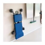 Ergochair wall hanger (5216087) shown holding an automotive creeper securely against a garage wall, demonstrating vertical storage and space-saving functionality