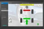 Wheel alignment screen instructing the technician to roll the vehicle forward for compensation