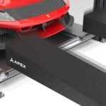 Close-up view of APEX hook-nose ramp locking into BendPak ramp receiver brackets on four-post lift