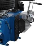 Side view of swing-arm tire changer showing bead breaker assembly and operator controls