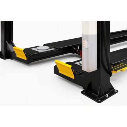 Close-up of four-post alignment lift runways with wheel chocks, turnplates, and heavy-duty steel columns mounted to the shop floor