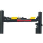 Side profile of four-post alignment lift with arrows indicating adjustable runway width between columns