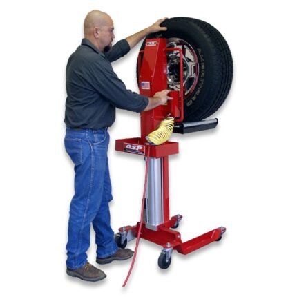 Technician using the QSP LM-200 tire lift to raise and position a mounted wheel, shown on a red mobile lift stand with caster wheels