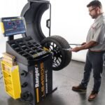 Technician operates the Ranger LS45DS wheel balancer for fast and accurate tire balancing.