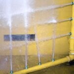 Water jet spray nozzles for cleaning parts