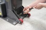 Quick-connect hydraulic hose fittings on MaxJax portable two-post lift.
