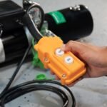 Close-up of the QuickJack BL-3500SLX handheld controller with up and down buttons for precise lift control. Designed for safe, straightforward operation during maintenance jobs.