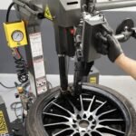 R80EX tire changer equipped with leverless bead lifter for ergonomic operation and high-volume tire shop efficiency.