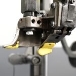 Technician using leverless bead lifter kit on tire changer for streamlined workflow, reduced fatigue, and consistent results.