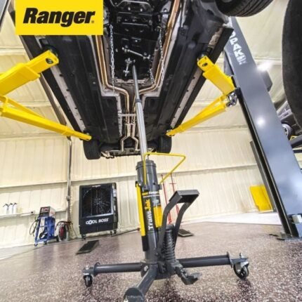 Ranger RTJ-1 transmission jack positioned under a raised vehicle on a two-post lift, supporting the drivetrain during service
