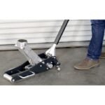 Ranger RFJ-4000AL aluminum floor jack raising a vehicle, shown in action with operator applying pump strokes