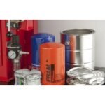 Oil filters and crushed cans staged next to the Ranger RP-20HD, emphasizing the unit’s recycling capability and shop-ready durability.