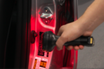 Technician scanning a vehicle’s VIN sticker using a handheld barcode scanner